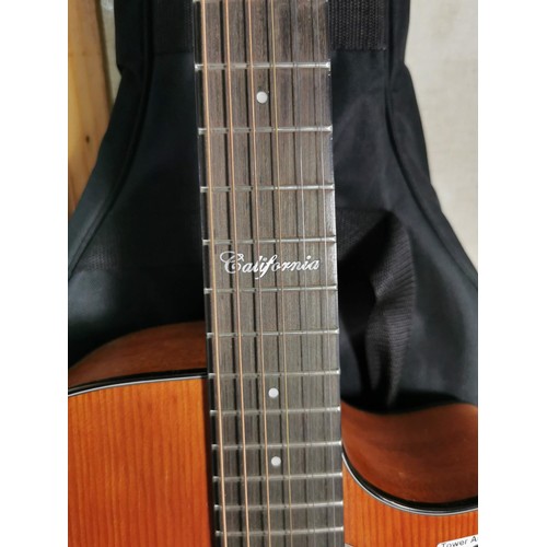 133 - A Taiga California series electro acoustic guitar, with gigbag in good order.