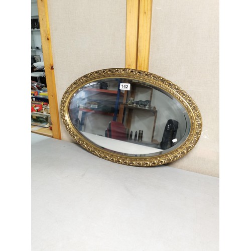 142 - An Adam Morris vintage wooden gilt framed bevel edged mirror in good order measures 39cm high 62cm w... 