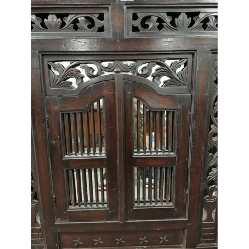 144 - Large impressive rosewood Indonesian shuttered mirror with carving to the edges, doors open to revea... 