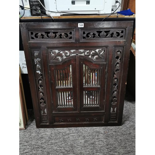 144 - Large impressive rosewood Indonesian shuttered mirror with carving to the edges, doors open to revea... 