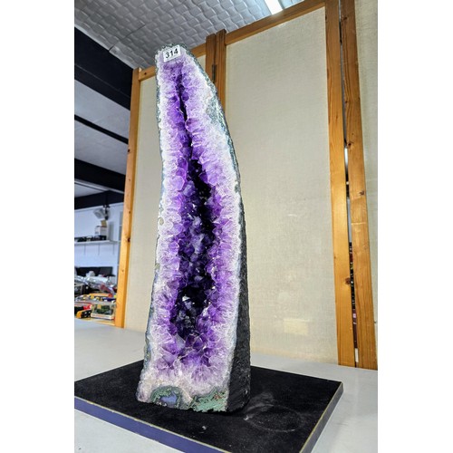 314 - A very large and impressive amethyst cathedral church geode in A grade quality standing at an impres... 