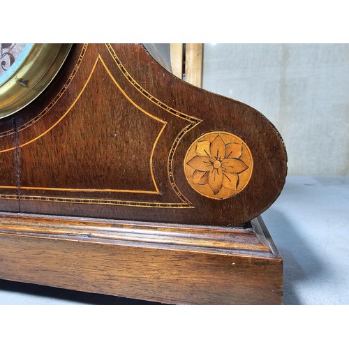 315 - An attractive mahogany vintage mantel clock featuring an unusual dome wooden top and inlay decoratio... 