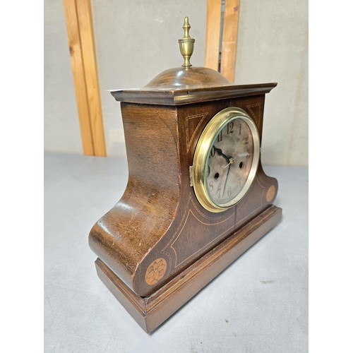 315 - An attractive mahogany vintage mantel clock featuring an unusual dome wooden top and inlay decoratio... 