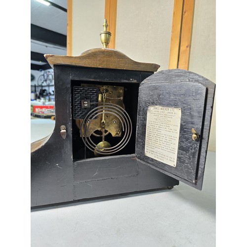 315 - An attractive mahogany vintage mantel clock featuring an unusual dome wooden top and inlay decoratio... 