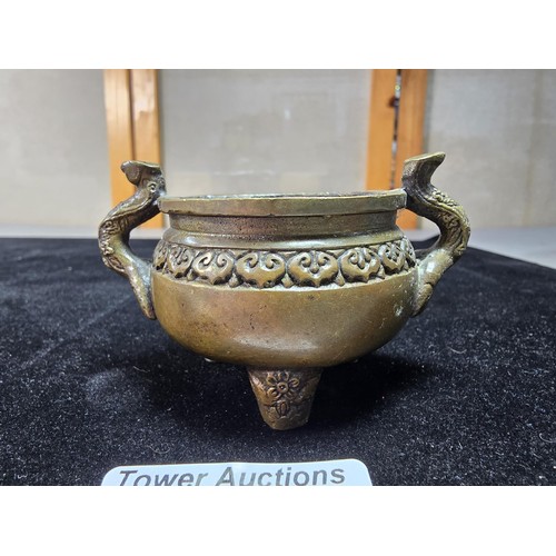 318 - An antique Chinese bronze incense burner having an ornate design with 2 handles either side and a fl... 