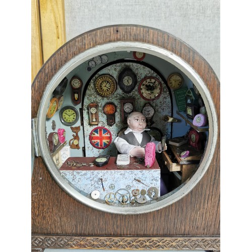 161 - Mantel clock case containing a very well detailed diorama of a man in a clock workshop, surrounded b... 