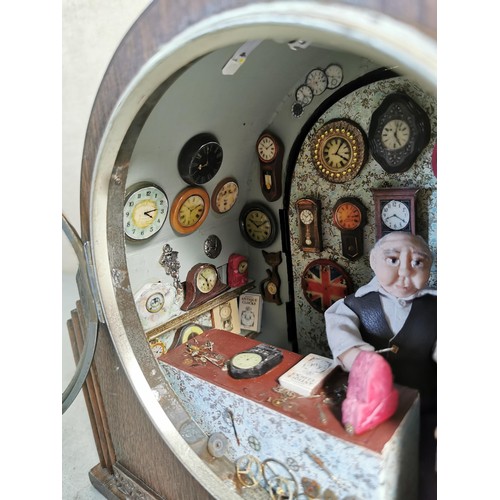 161 - Mantel clock case containing a very well detailed diorama of a man in a clock workshop, surrounded b... 