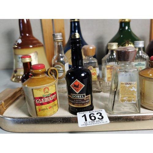 163 - Quantity of collectable glass bottles, along with 4x empty decanters inc Bells, Glenfiddich etc alon... 