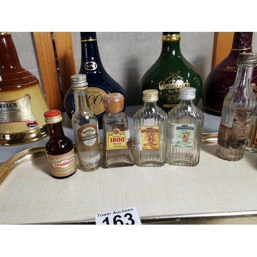 163 - Quantity of collectable glass bottles, along with 4x empty decanters inc Bells, Glenfiddich etc alon... 