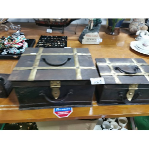 327 - A quantity of 3x arts & crafts graduated metal and brass banded storage trunks with cast iron handle... 