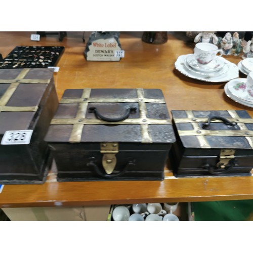 327 - A quantity of 3x arts & crafts graduated metal and brass banded storage trunks with cast iron handle... 