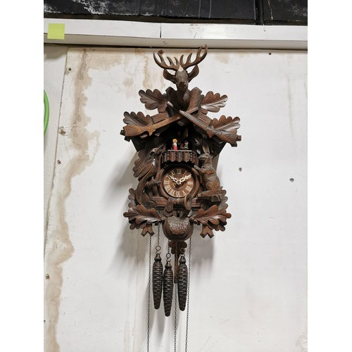 150 - Large Swiss Black Forest Cuckoo clock with carved decoration to the front depicting a Hare and Woodp... 