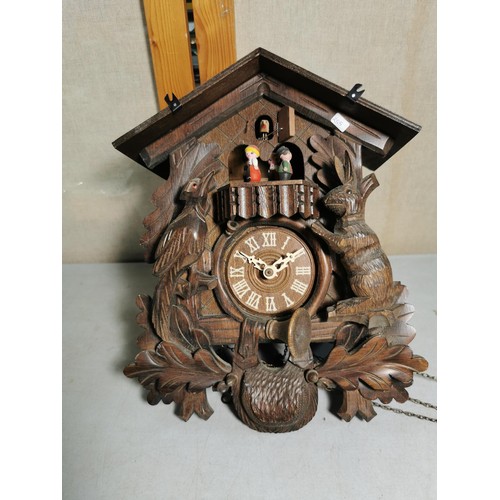 150 - Large Swiss Black Forest Cuckoo clock with carved decoration to the front depicting a Hare and Woodp... 