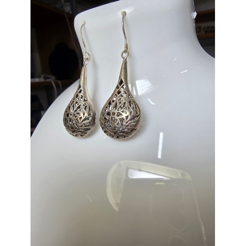 233 - A pair of large and ornate 925 silver drop earrings with an intricate pierced design, the earrings a... 