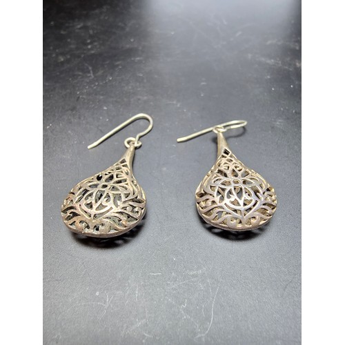 233 - A pair of large and ornate 925 silver drop earrings with an intricate pierced design, the earrings a... 