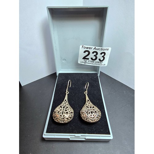 233 - A pair of large and ornate 925 silver drop earrings with an intricate pierced design, the earrings a... 