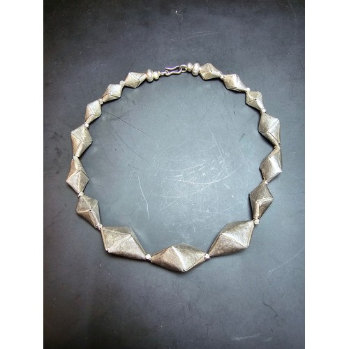 234 - An interesting hand made sterling silver necklace, each bead is folded and shaped pieces of sterling... 