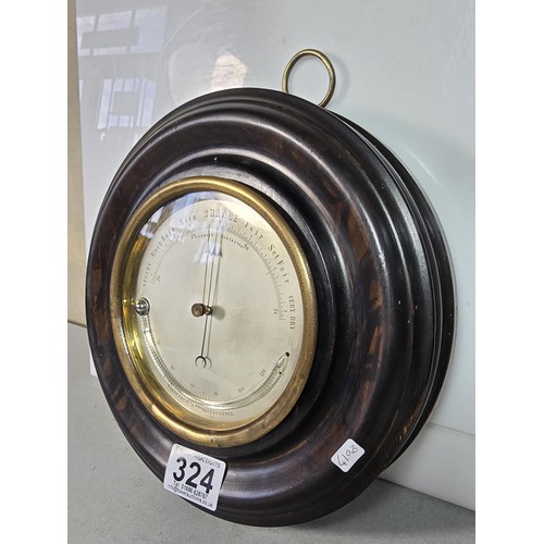 324 - A good early antique aneroid barometer featuring a good turned solid wood case presenting an excelle... 