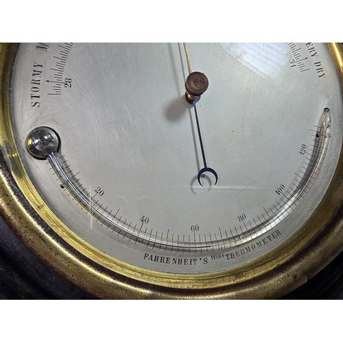 324 - A good early antique aneroid barometer featuring a good turned solid wood case presenting an excelle... 