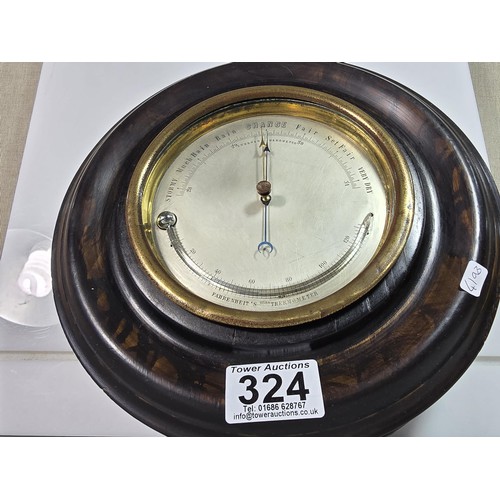 324 - A good early antique aneroid barometer featuring a good turned solid wood case presenting an excelle... 