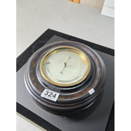 324 - A good early antique aneroid barometer featuring a good turned solid wood case presenting an excelle... 