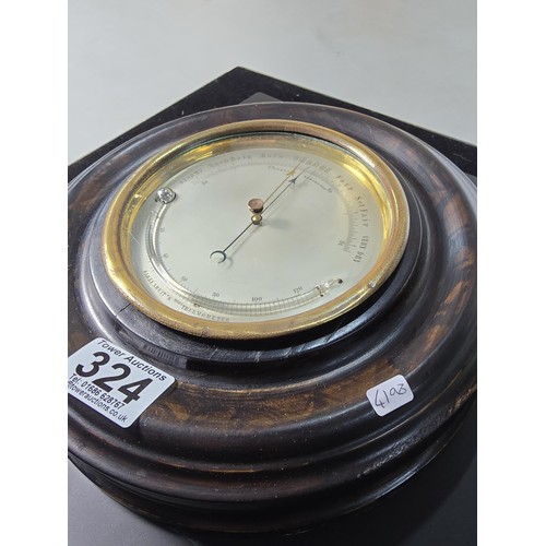 324 - A good early antique aneroid barometer featuring a good turned solid wood case presenting an excelle... 