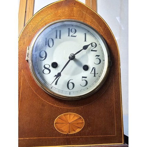 325 - An attractive antique lancet shaped mahogany mantel clock with string inlay and inlay panel to the f... 