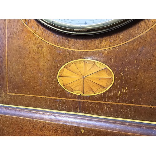 325 - An attractive antique lancet shaped mahogany mantel clock with string inlay and inlay panel to the f... 