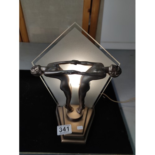 341 - Striking Art deco style table lamp featuring a man and woman figures holding hands to front with a g... 