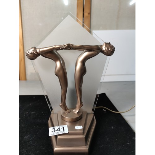 341 - Striking Art deco style table lamp featuring a man and woman figures holding hands to front with a g... 