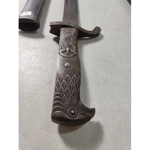 351 - WWII Reproduction German third Reich bayonet with sheath featuring an Eagle handle and a Swastika ma... 