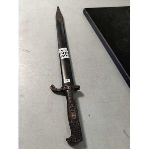 351 - WWII Reproduction German third Reich bayonet with sheath featuring an Eagle handle and a Swastika ma... 