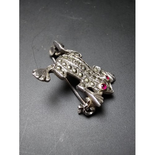 241 - A pretty vintage 925 silver brooch in the form of a frog inset  with marcasite stones having red spi... 