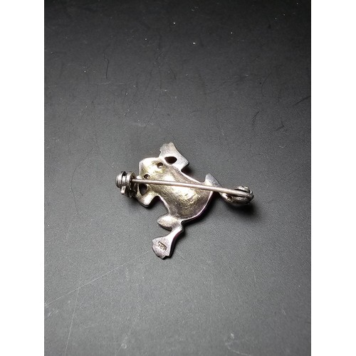 241 - A pretty vintage 925 silver brooch in the form of a frog inset  with marcasite stones having red spi... 