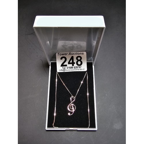 248 - A new and unused 925 silver treble clef formed pendant on an 18