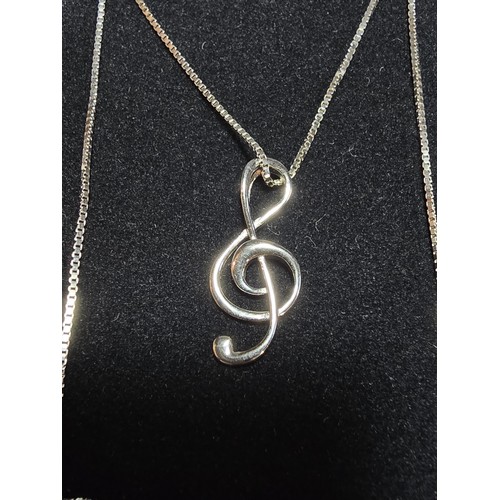 248 - A new and unused 925 silver treble clef formed pendant on an 18