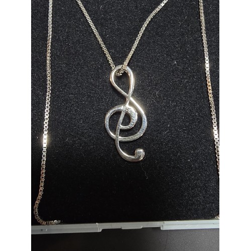 248 - A new and unused 925 silver treble clef formed pendant on an 18