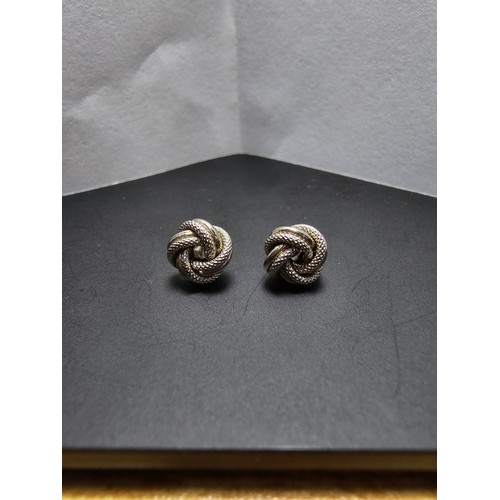 250 - A boxed pair of hallmarked 9ct white gold knot formed stud earrings along with a boxed 925 silver ri... 