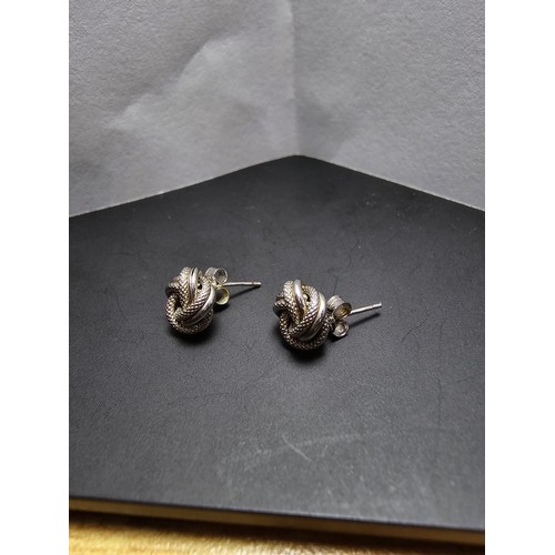 250 - A boxed pair of hallmarked 9ct white gold knot formed stud earrings along with a boxed 925 silver ri... 