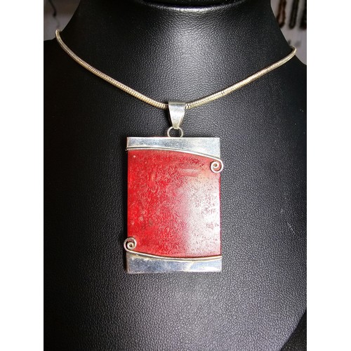 254 - A large 925 silver pendant featuring a red panel set on a good chunky  16