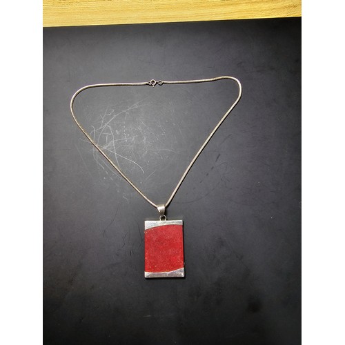 254 - A large 925 silver pendant featuring a red panel set on a good chunky  16