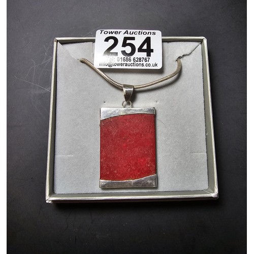 254 - A large 925 silver pendant featuring a red panel set on a good chunky  16