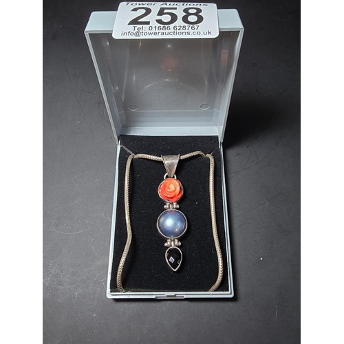 258 - A good quality large 925 silver drop pendant inset with a large blue natural pearl, a carved hard st... 