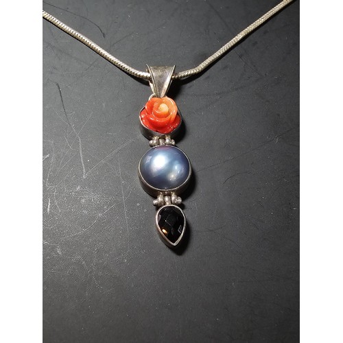 258 - A good quality large 925 silver drop pendant inset with a large blue natural pearl, a carved hard st... 