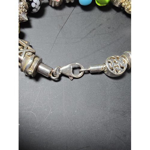 272 - A heavy comprehensive 925 sterling silver charm bracelet containing 16 sterling silver charms which ... 