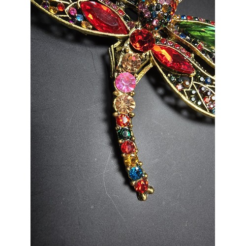 276 - A suite of 7x ornate jewelled dragonfly formed brooches which includes a large ornate multi jewelled... 