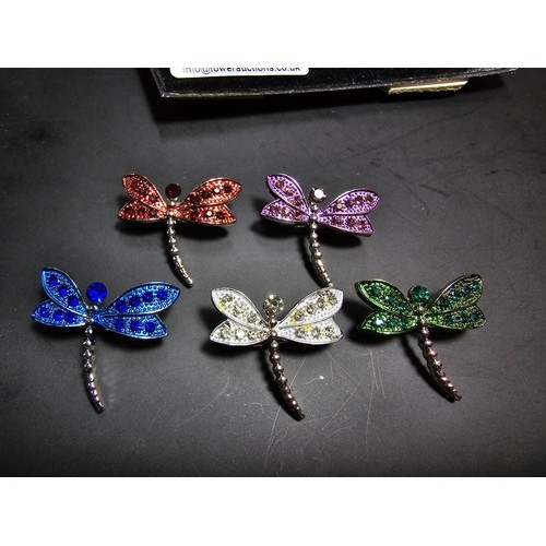 276 - A suite of 7x ornate jewelled dragonfly formed brooches which includes a large ornate multi jewelled... 