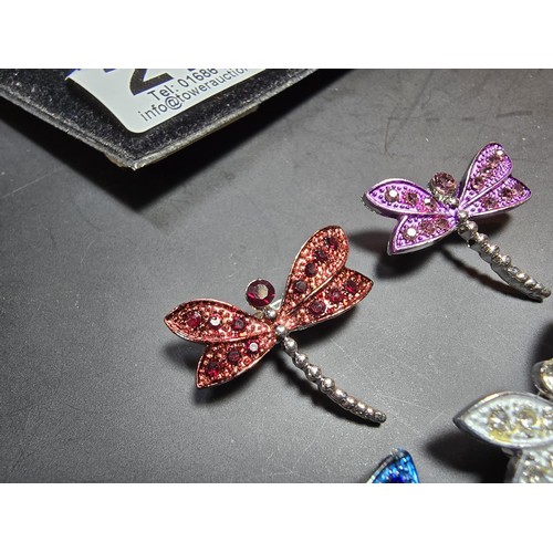 276 - A suite of 7x ornate jewelled dragonfly formed brooches which includes a large ornate multi jewelled... 