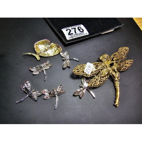 276 - A suite of 7x ornate jewelled dragonfly formed brooches which includes a large ornate multi jewelled... 