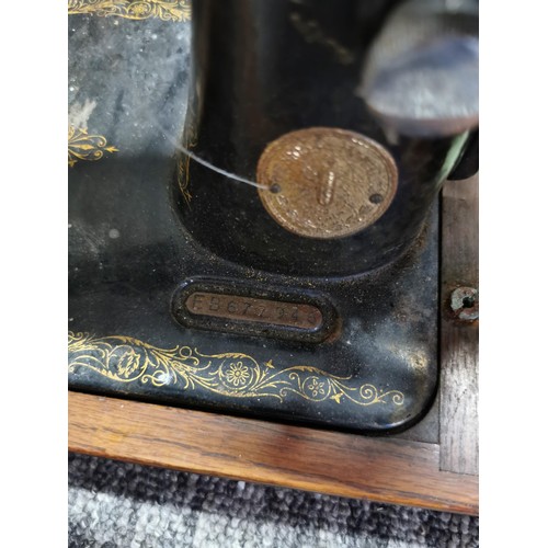 366 - Large dog basket full of various odds along with an antique Singer sewing machine with its original ... 